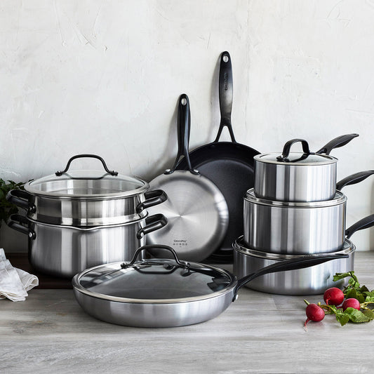 GreenPan ceramic cookware set with pots, pans, and lids on a kitchen counter, fresh radishes beside them.