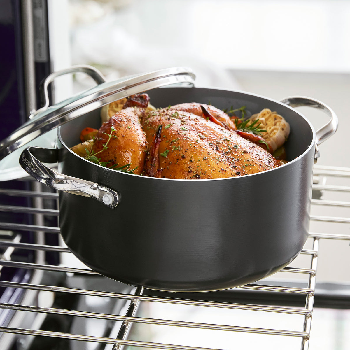 Herb-roasted chicken in a gray Valencia Pro ceramic nonstick pot on an oven rack.