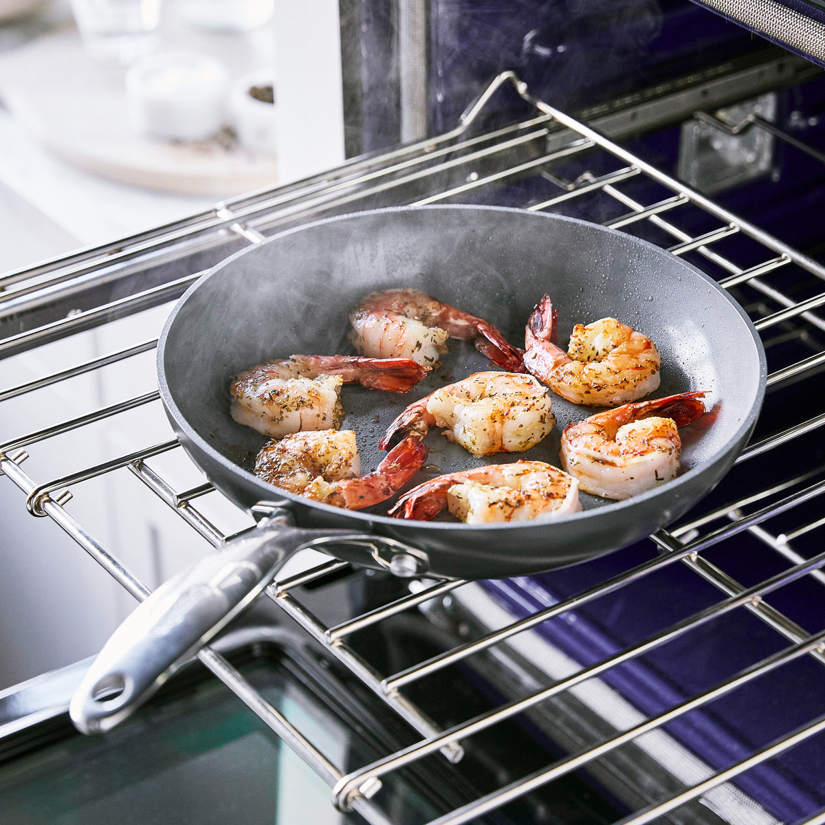 Shrimp cooking in an 8-inch Valencia Pro ceramic nonstick frypan with visible steam rising.