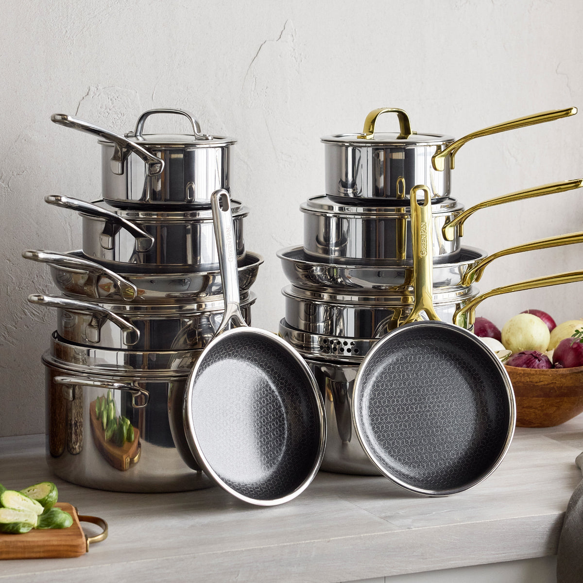 10-piece cookware set with white ceramic nonstick pots and pans, all featuring gold handles.