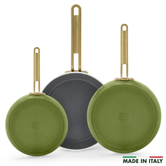 Three green frypans with gold handles on a white background